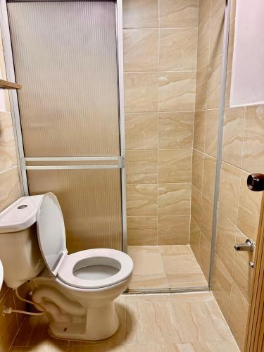 a bathroom with a toilet and a shower at Hotel Flamante Bulevar in Bogotá