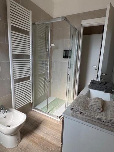 a bathroom with a shower and a toilet and a sink at Tarvisium Apartment in Treviso