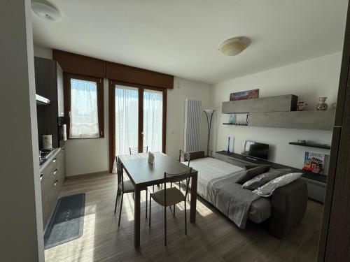 a bedroom with a bed and a table and a desk at Tarvisium Apartment in Treviso