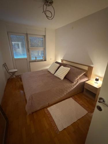 a bedroom with a bed with two pillows on it at DiSte Apartman in Knin