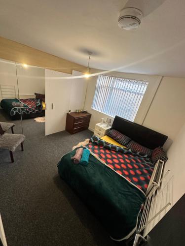 a bedroom with a large bed in a room at Quiet room Nr2 in Coundon