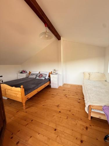 a bedroom with two beds and a wooden floor at Вила Чочита in Trapeskovtsi