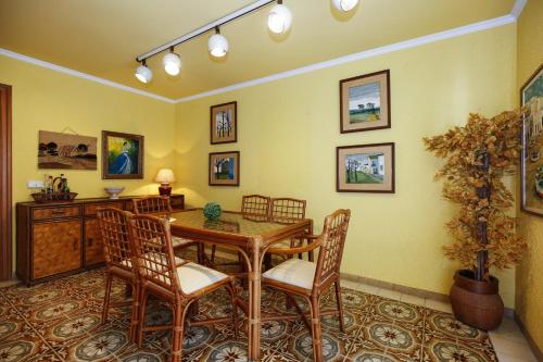 a dining room with a wooden table and chairs at Villa Cococha in Salou