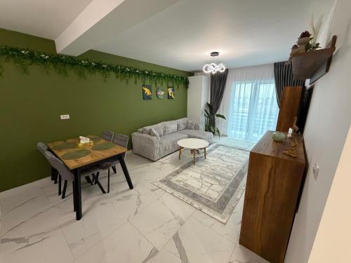 a living room with a table and a couch at Emerald House 5 in Scheia