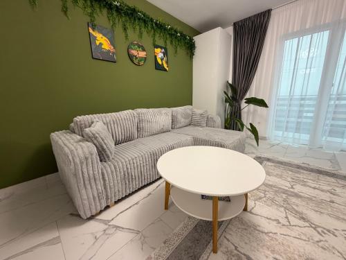a living room with a couch and a table at Emerald House 5 in Scheia