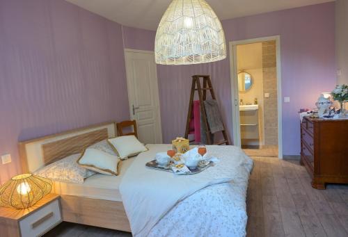 a bedroom with a bed with a teddy bear on it at Rouges-Gorges 