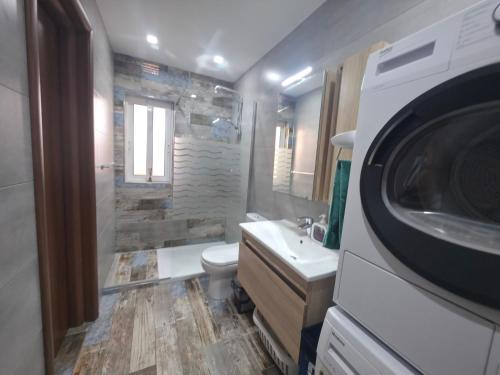 a bathroom with a toilet and a sink and a shower at Il Bejta penthouse in Qala