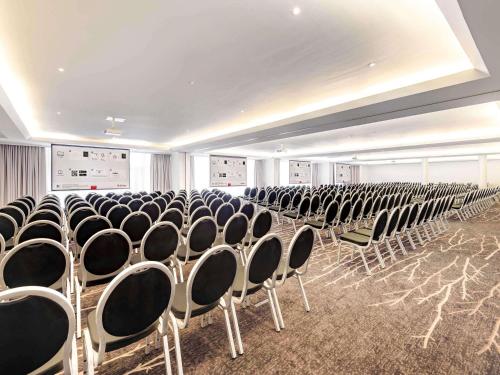 a room with rows of chairs in a building at Mercure Düsseldorf Kaarst in Kaarst