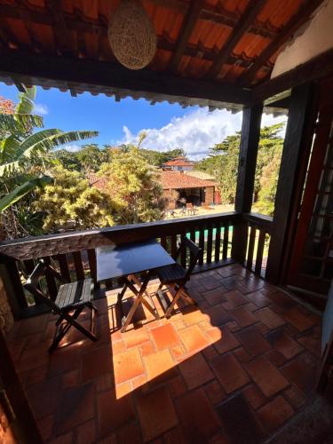 a table and chairs on a balcony with a view at Numa Boa HOSTEL Búzios in Búzios