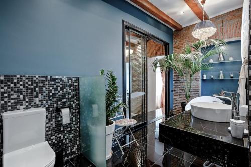 a bathroom with a sink and a tub with plants at Eiffel Grand View in Paris
