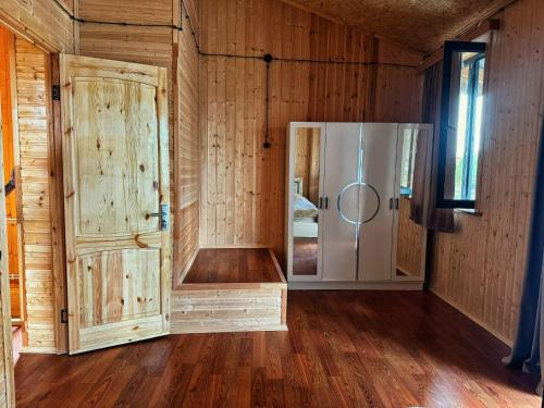 a room with a shower and a refrigerator at Casa nostra in Ambrolauri