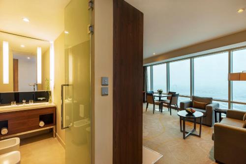 a bathroom with a living room and a dining room at InterContinental Doha The City by IHG in Doha