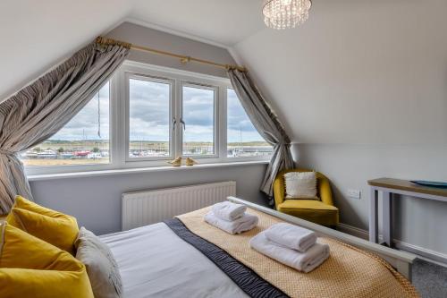 a bedroom with a bed with two towels on it at 4 Bed in Amble oc-gd1868 in Amble