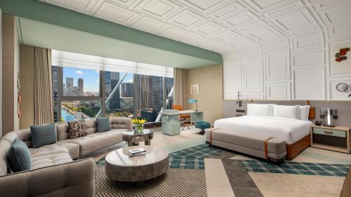 a hotel room with a bed and a couch at Hotel Indigo Ningbo by IHG in Ningbo