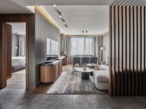 a hotel suite with a living room and a bedroom at Crowne Plaza Sofia by IHG in Sofia