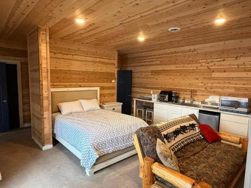 a bedroom with a bed in a wooden room at Cedar Studios at Whitetail Estates in Babbitt