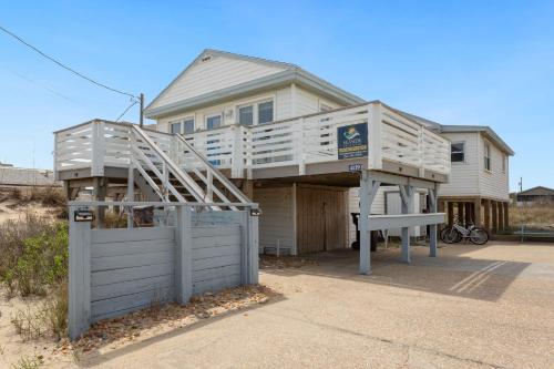 a house with a deck on top of a garage at 4119 - The Dolphin Boat in Kitty Hawk