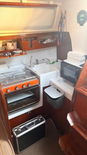 a kitchen with a sink and a stove and a toilet at Viana Sealife in Viana do Castelo