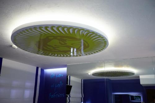 a green plate on the ceiling of a room at Veritas Boutique Art Hotel in Veria