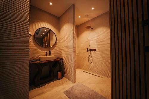 a bathroom with a sink and a mirror at Hotel Casino Elite in Quiévrain