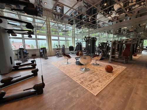 a gym with chairs and exercise equipment on a wooden floor at revita - naturresort & spa in Bad Lauterberg