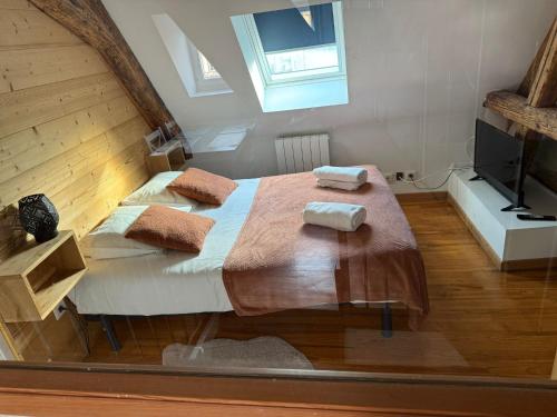 a bedroom with a bed with two towels on it at Les Appartements de Home Petite Venise in Colmar