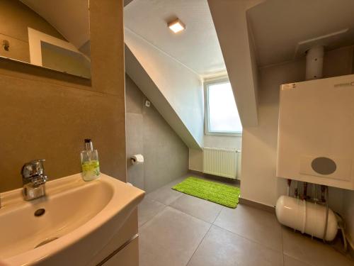 a bathroom with a sink and a toilet and a window at Kamus in Baden-Baden