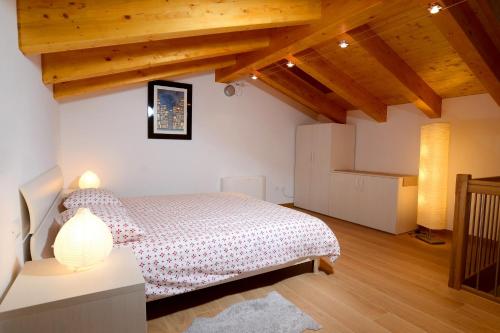 a bedroom with a bed and wooden ceilings at B&B Sgonico in Sgonico
