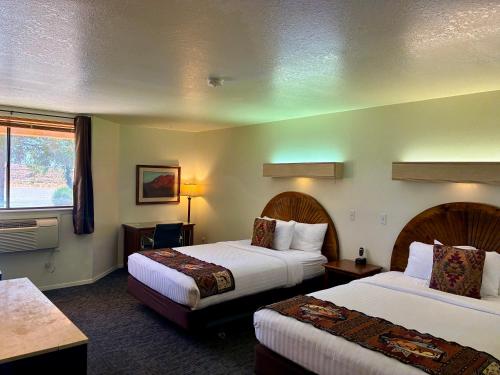 a hotel room with two beds and a window at Ticaboo Lodge in Ticaboo