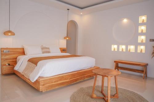 a bedroom with a large bed and a stool at Montelago Batur in Bangli