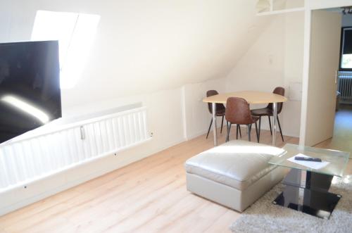 a living room with a table and a couch at Beautiful apartment in Treuchtlingen
