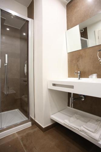 a bathroom with a sink and a shower at Hotel Columbia Wellness & Spa in Montecatini Terme
