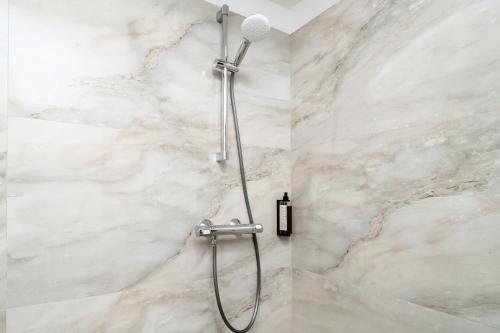 a shower with a microphone in a bathroom at Airport Hotel - Baia Mare - Maramures in Baia Mare
