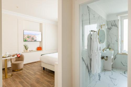 a bedroom with a bed and a sink and a mirror at Monastero San Pietro Claver in Rome