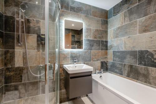 a bathroom with a sink and a shower and a tub at 2 Bed in Otterden oc-c36010 in Otterden