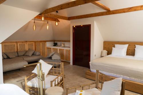 a living room with a bed and a couch at Namus House in Stepʼanavan
