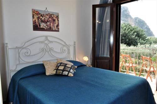 マカリにあるCamere da Mariolinaのベッドルーム1室(青い毛布、窓付)