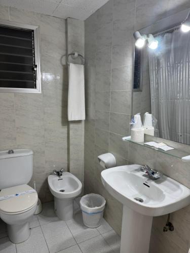 a white bathroom with a toilet and a sink at Plaça Vella in Sant Carles de la Ràpita