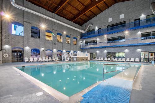 a large swimming pool with chairs in a building at Massanutten Resort by TripForth in McGaheysville