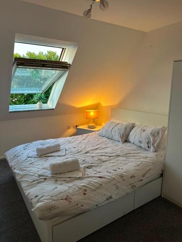 a bedroom with a white bed with a window at EazyStay in Avonmouth