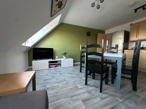 a kitchen and dining room with a table and chairs at EazyStay in Avonmouth