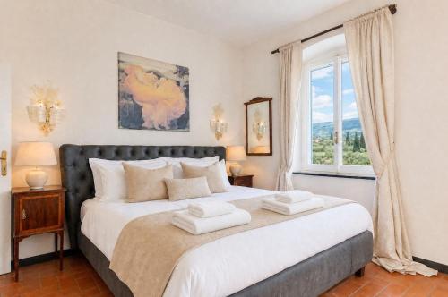 a bedroom with a large bed and a window at Villa with Pool e Jacuzzi Free Parking AC in San Lorenzo della Costa