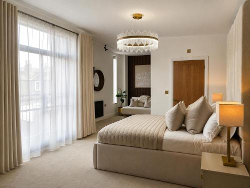 a bedroom with a bed and a large window at Cedar House at The Old Fire Station in Canterbury