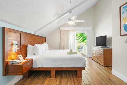 a bedroom with a large bed and a television at Margaritaville Vacation Club - St Thomas in Frydendal