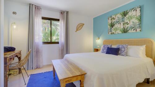 a bedroom with a bed and a desk and a window at NEW CASA BLU - Oasis Tamarindo 1 in Corralejo