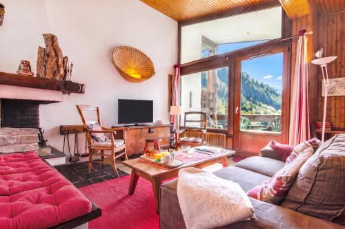 a living room with a couch and a table at Chalet Dava La Via ski in - ski out - Happy Rentals in Chamonix