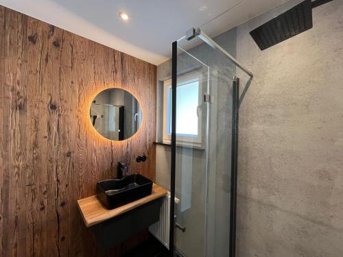 a bathroom with a sink and a glass shower at Ferienhaus Kropsbach in Sankt Martin