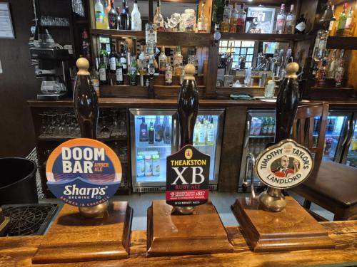 a group of bottles of beer on display in a bar at The Crewe Arms Hotel in Crewe