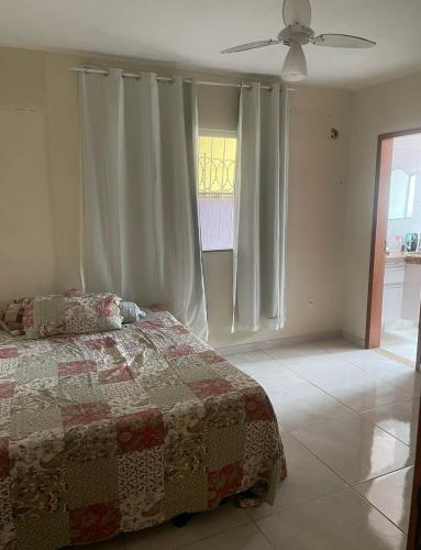 a bedroom with a bed and a ceiling fan at Casa em Maricá- Paraiso Itaipuaçu in Maricá