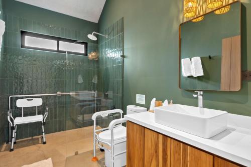 a bathroom with a sink and a shower at Selvatico Tamarindo Villas in Tamarindo
